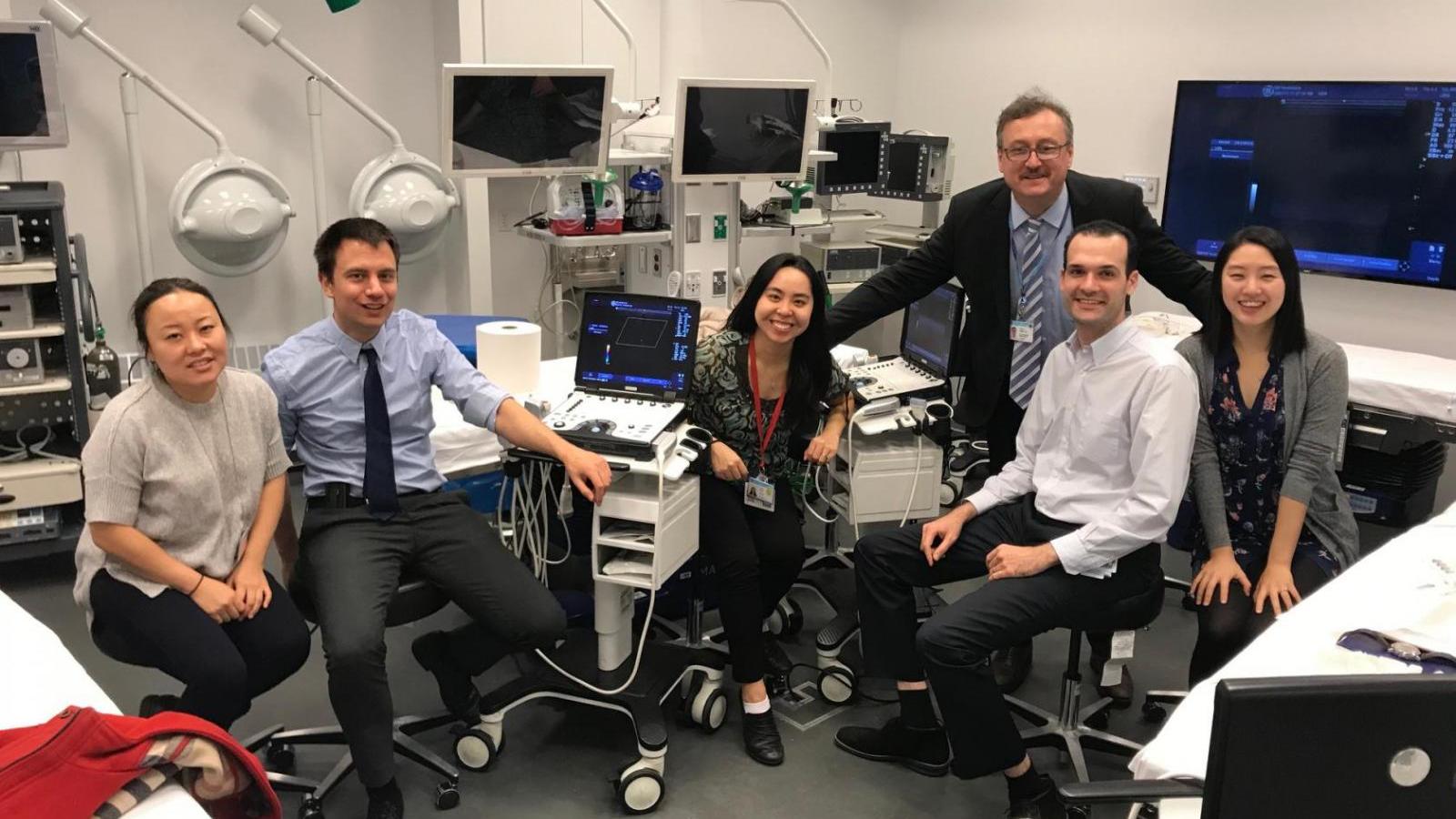 Rheumatology fellows pose in ultrasound room.