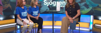 Two women sitting with interviewer on news channel