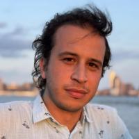 Nacim Kerrouche headshot with river water and skyline in background